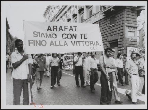 A banner at a demonstration proclaiming solidarity with Palestine's leader, Yasser Arafat
