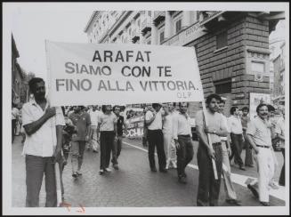 A banner at a demonstration proclaiming solidarity with Palestine's leader, Yasser Arafat