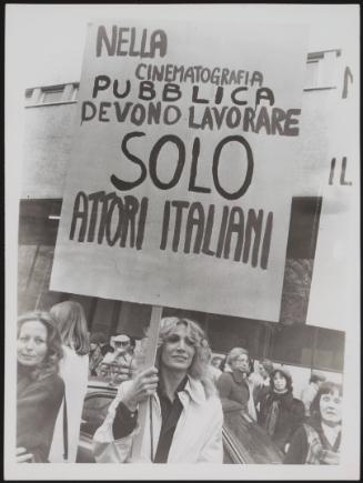 A woman holds a protest placard criticising the casting in Italian cinema 