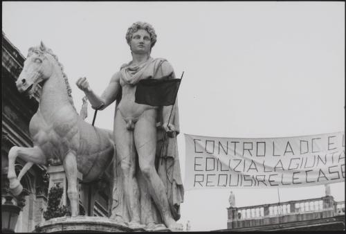 The ancient statue of Castor on the Piazza del Campidoglio in Rome holds one end of a protest banner