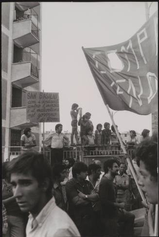 A protest in the San Basilio area of Rome, an area in the north-east of Rome famous for its high levels of crime and poverty. One man's placard says that the area is 'with the unions against the inertia and the immorality of the government in Rome'.