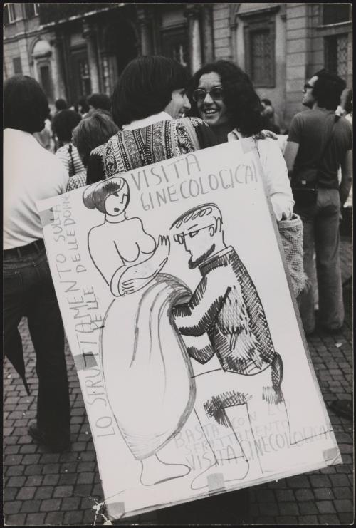 At the feminist demonstration a hand drawn placard caricaturing a gynaecological examination