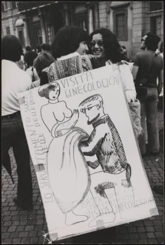 At the feminist demonstration a hand drawn placard caricaturing a gynaecological examination
