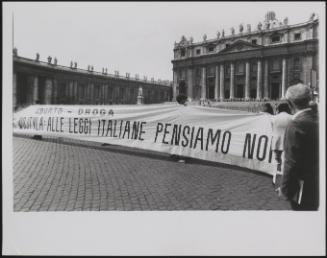 A long protest banner is held outside a state building warning Pope Wojtvla about Italian laws