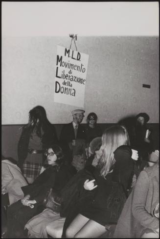 People assemble for a meeting of the M.L.D- Movement for the Liberation of Women