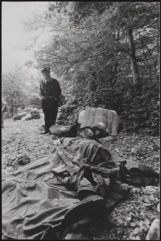 Policemen deal with the aftermath of a gun battle with neo-fascists on L ' Rascino Plateau in which right-wing extremist Giancarlo Esposti was shot dead