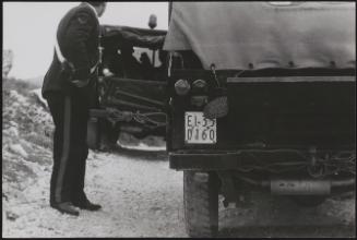 Policemen deal with the aftermath of a gun battle with neo-fascists on L ' Rascino Plateau in which right-wing extremist Giancarlo Esposti was shot dead