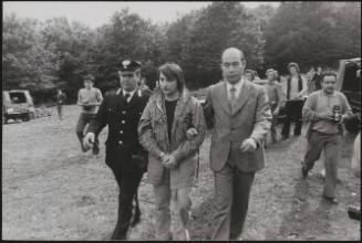 Policemen lead away Alessandro D'Intino in handcuffs in the aftermath of a gun battle with neo-fascists on L' Rascino Plateau in which right-wing extremist Giancarlo Esposti was shot dead