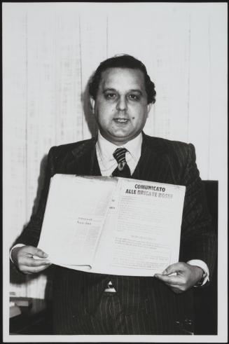 Giovanni Furfano holds up a Red Brigades press statement