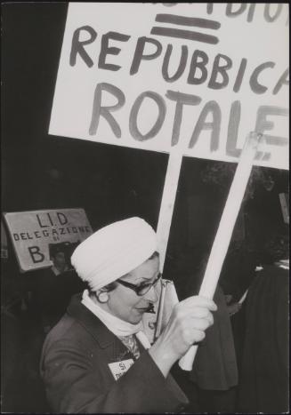 A woman holds a placard at a protest about the divorce law