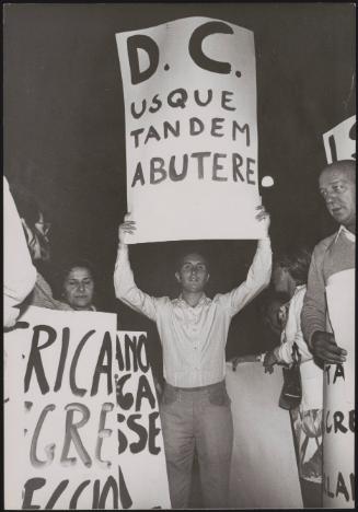 A man holds up a protest placard that reads:
'D.C. usque tandem abutere' (The Christian Democrats abuse) at an anti divorce demonstration