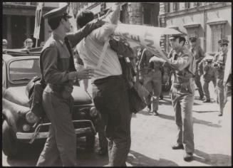 A divorce lawyer stopped by the police as he protests in front of Palazzo Chigi, Rome