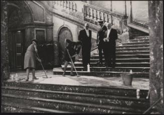 Guards and staff inspect cleaning work on the Egmont Palace grand stairs before the visit of British Prime Minister Harold Macmillan
