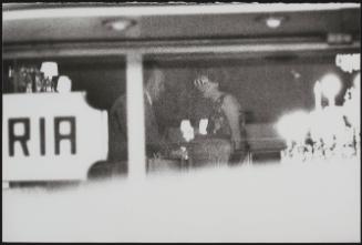 A covert picture taken of a couple through a restaurant window 