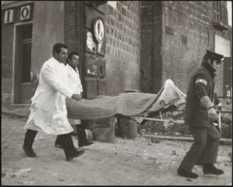 A victim is carried out on a stretcher after an explosion 