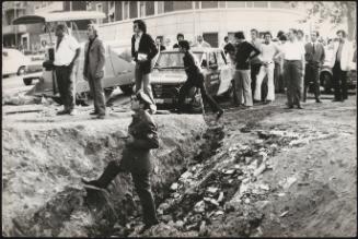 A crowd of spectators and armed policeman 