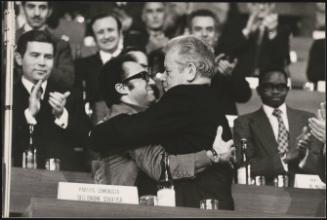 Communist party members, including Domingo Abrantes, embrace at an assembly