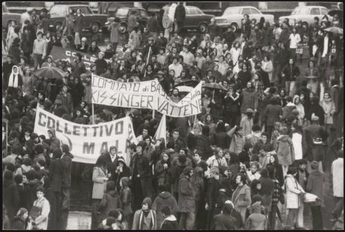 Communist banners and anti-Kissinger banners can be seen amongst a student protest
