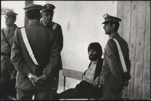 A member of NAP, guarded by four police men 