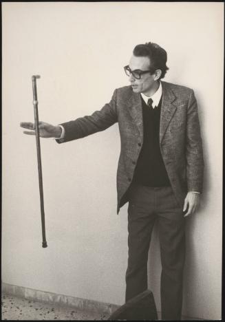 Professor Mareo Nicoletti holding out a walking stick