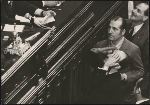 Socialist politicians Francesco Principe and Luigi Preti walk up to the gallery where other politicians sit in a legislative assembly 