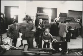 Young boys are shown tanks and other defence vehicles on Armistice day