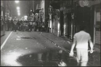 Street scene at night. Rioters.