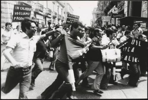 A crowd of protesters demonstrating in aid of strikes in factories. 