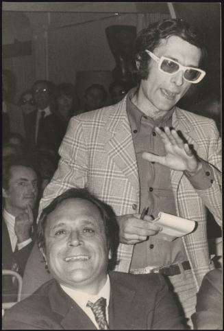 Luca Formenton (standing) amongst seats in an assembly