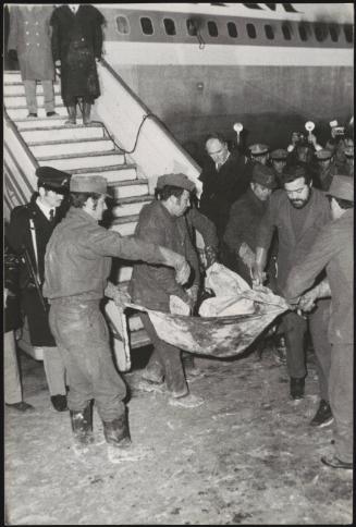 A body of a victem is carried off the Pan Am plane attacked by terrorists in 1973 at the Rome Fiumicino airpost