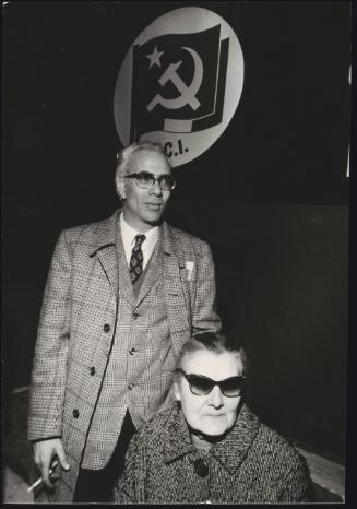 Rachele Torri, Pietro Valpreda's Great Aunt (seated). The Italian Communist Party flag hangs on the wall behind. 