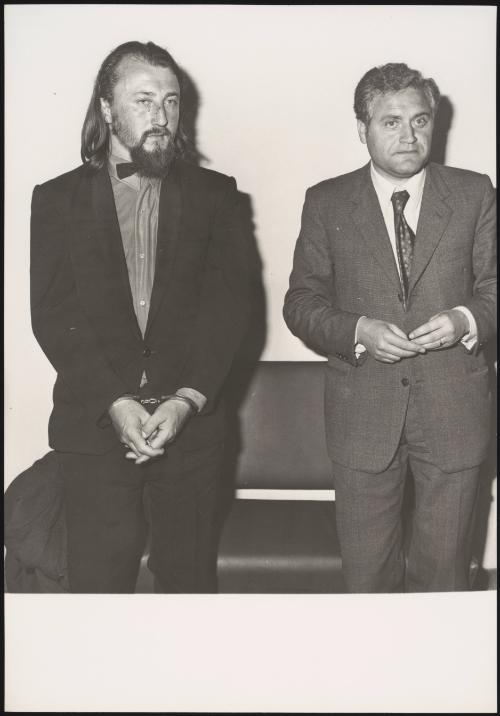 Laszlo Toth stands handcuffed next to his lawyer, after attacking and damaging La Pieta sculpture.