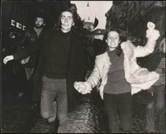 Anarchist demonstrators running hand-in-hand