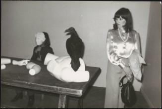 A young woman walks around the installlation 'Musical Action' by Yannis Kounellis. 