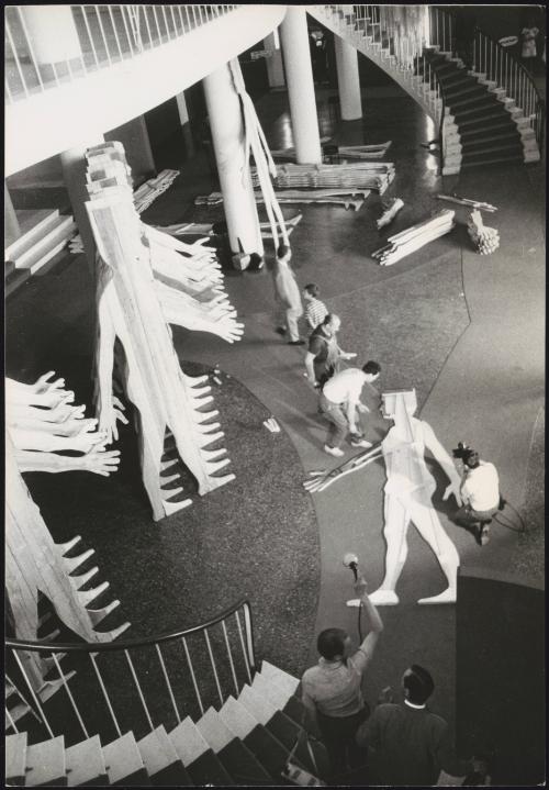 At Palazzo del Cinema di Venezia in Lido di Venezia, workmen and technicians put together a large sculpture by Mario Ceroli