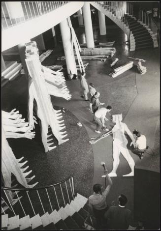 At Palazzo del Cinema di Venezia in Lido di Venezia, workmen and technicians put together a large sculpture by Mario Ceroli