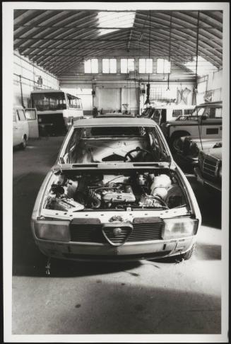 A car without its hood in a workshop