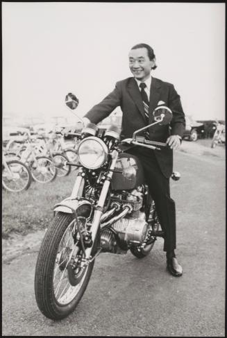 Kiyoshi Kawashima, president of Honda sitting on one of their motorbikes