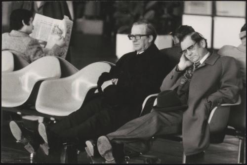 Two business men in an airport waiting lounge