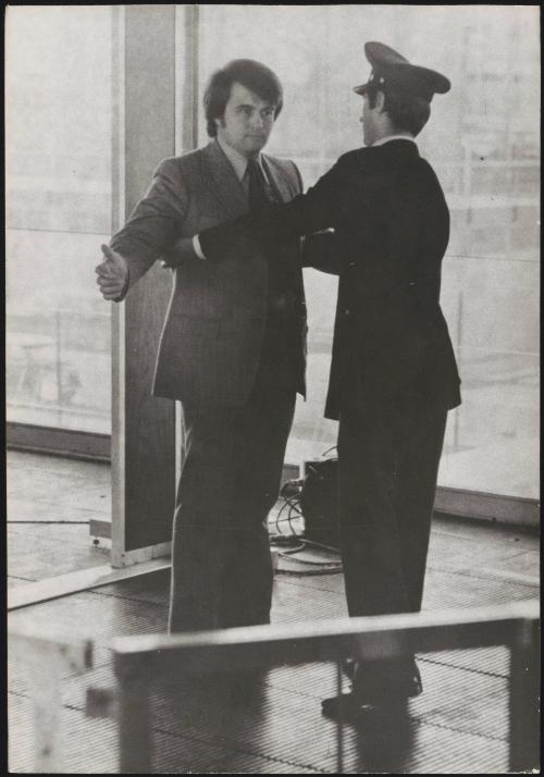 A man is patted down in security checks at an airport 