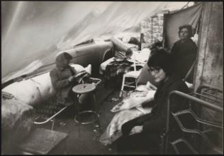 Three women in their temporary shelter with many salvaged items, in the aftermath of the destruction from the Belice earthquake, 1968, Sicily