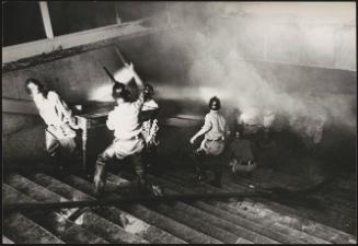Firefighters on steps dealing with dust and fire in the aftermath of the Belice earthquake in Sicily, 1968
