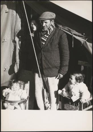 A man and wife and two young children in the doorway of their temporary shelter camp after being displaced by the Belice earthquake in Sicily 1968 