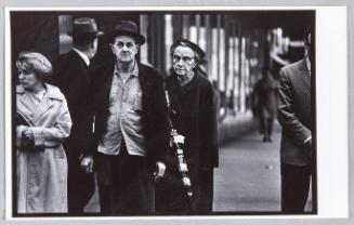 Kansas City, Kansas [Man with hat, woman with umbrella]