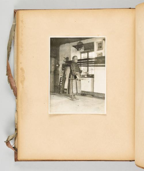 [A woman works with yarn on a large wooden frame] Page 53 of Quebec I; from collection of Canadian albums compiled by Edith S. Watson, 1890s-1930s