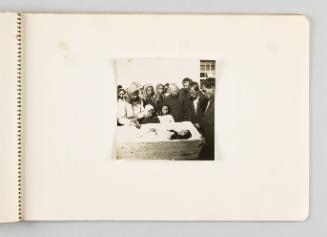 [Mourners are photographed around the open casket of a woman] [Page 57 of The Doukhobors I album]