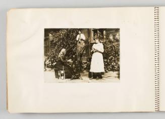 [Three women outside of home knitting and using spinning wheel, page 36 of The Doukhobors I album]