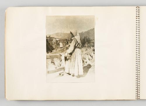 [Woman in cutting crops in yard with hilly view, page 34 of The Doukhobors I album