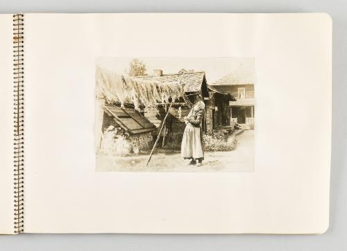 [Woman in headscarf hanging crops to dry, page 29 of The Doukhobors I album]