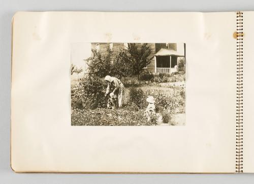 [Woman tending to garden with two children, page 10 of The Doukhobors I album]